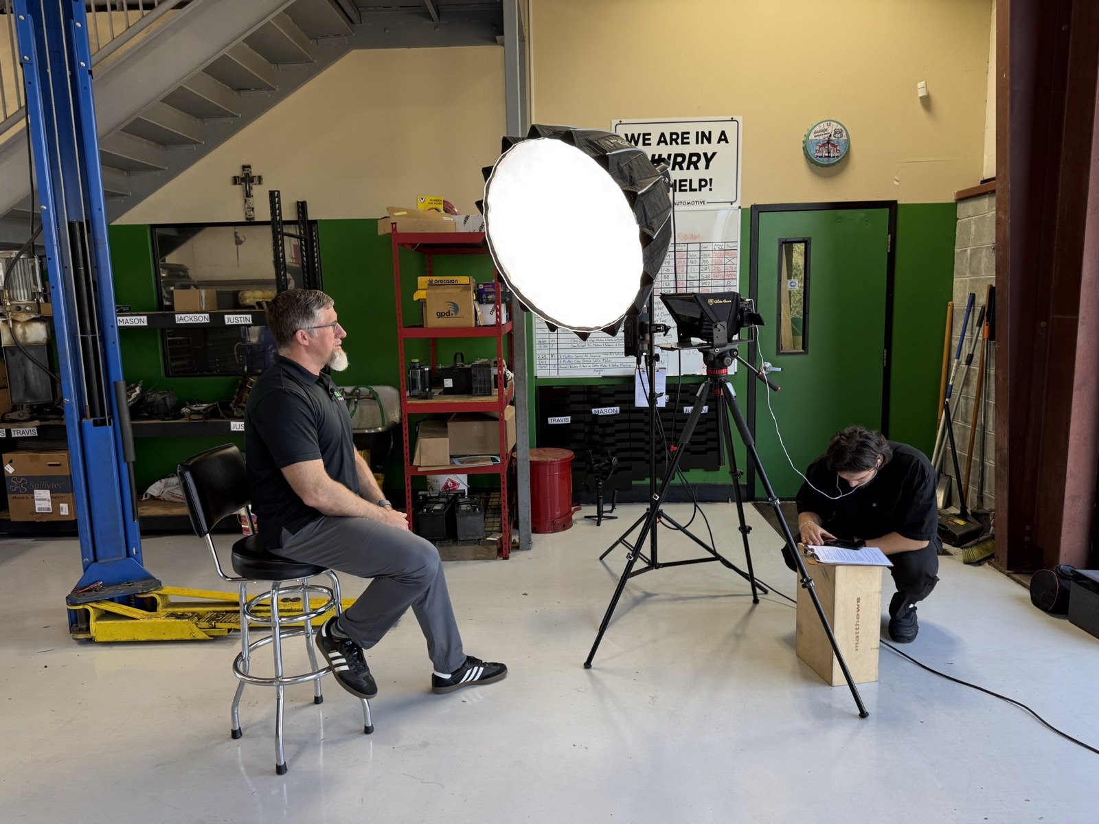 Focus Films crew filming an interview in an auto shop