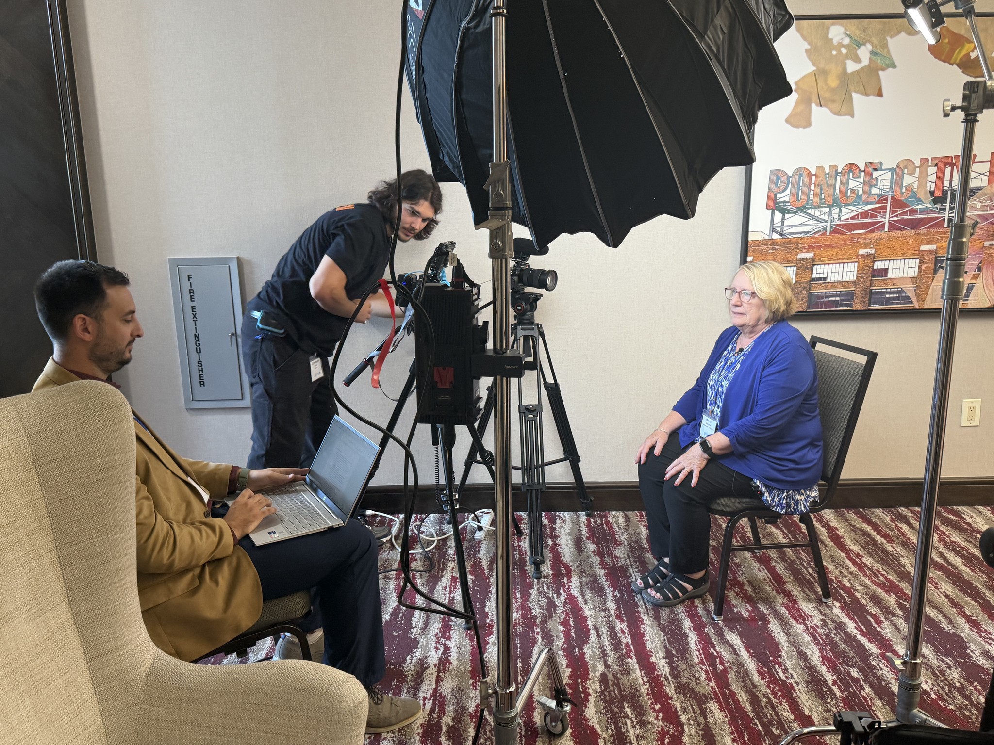 Focus Films crew filming a client interview in a hotel suite