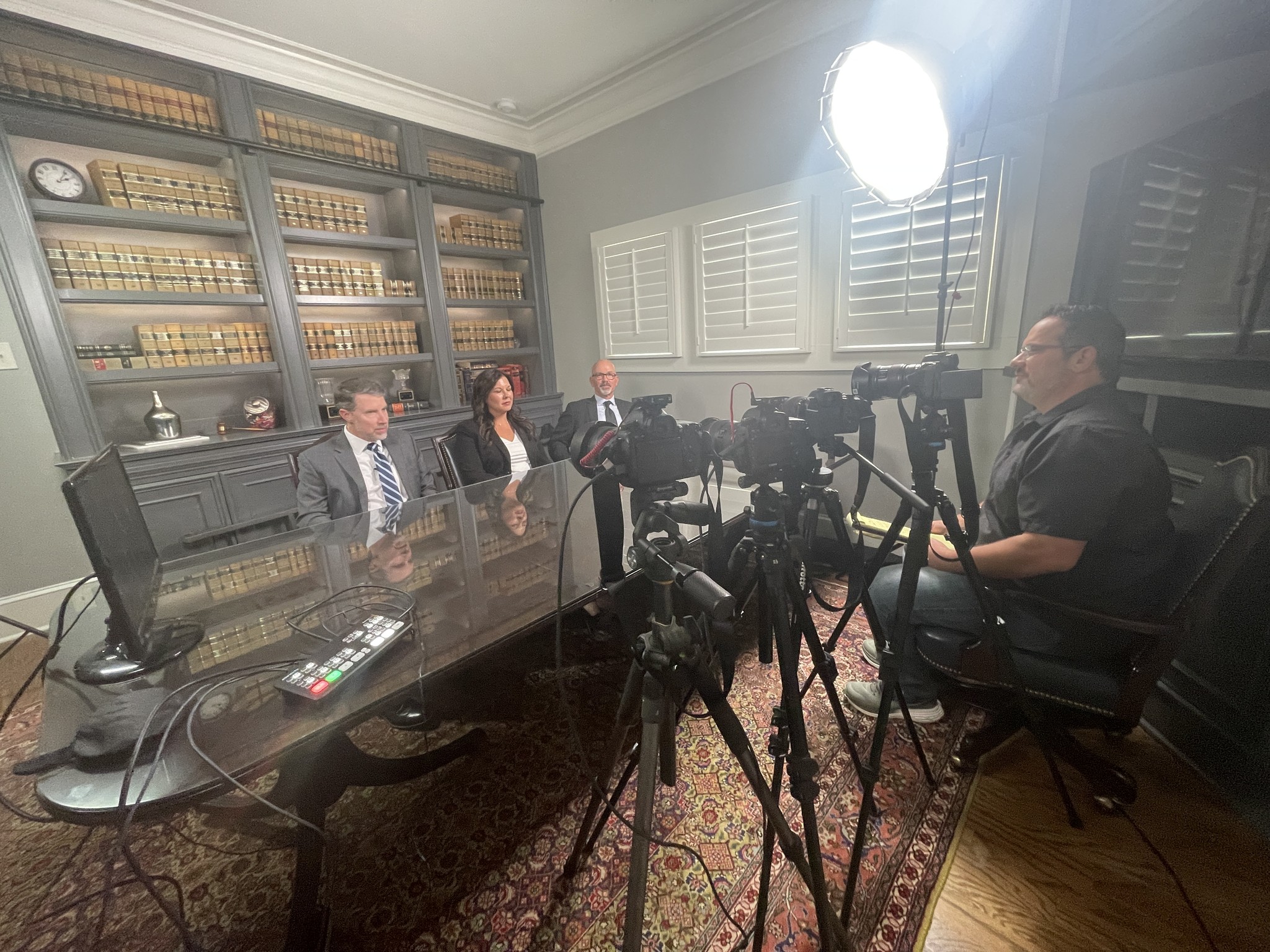 Focus Films crew filming a three-person panel interview in a law office